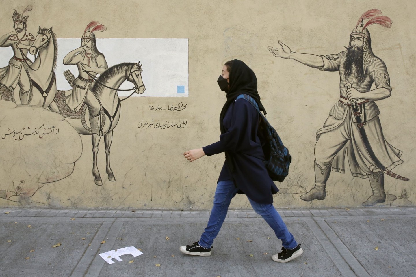 Ein Mädchen geht in Teheran an einer Häuserfassade entlang. Seit einigen Tagen ist die Vergiftungswelle an Schulen im Iran das beherrschende Thema in den heimischen Medien.