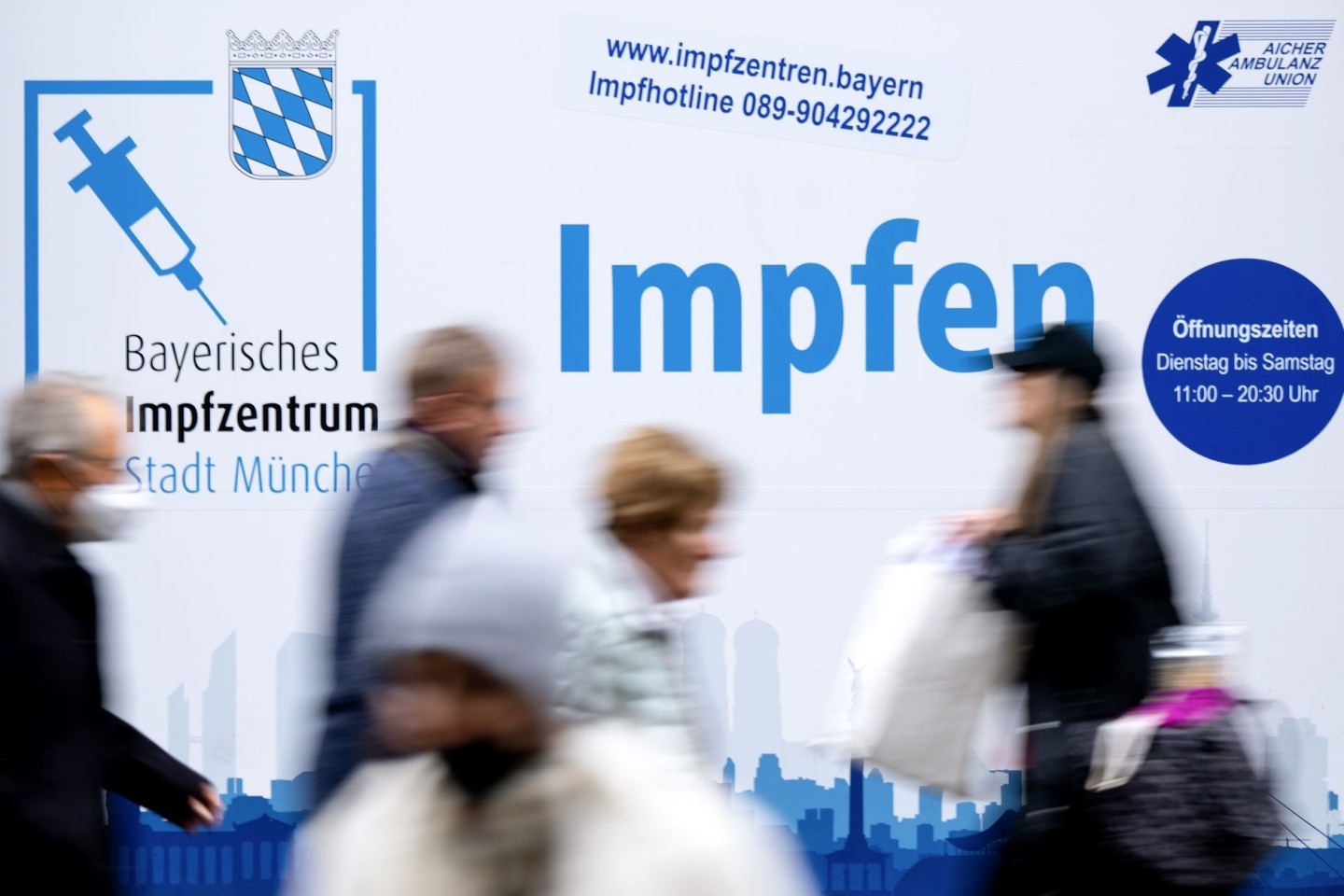 Passanten gehen an einem Impfzentrum in der Münchener Innenstadt vorbei.