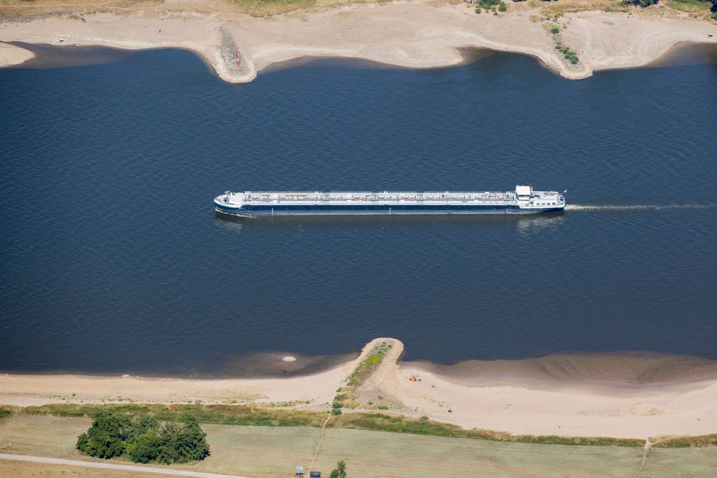 Ein Schiff mit wenig Ladung fährt bei Köln bei niedrigem Wasserstand auf dem Rhein.